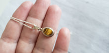 Load image into Gallery viewer, Vintage small oval tiger eye sterling silver  pendant on 18&quot; 925 silver chain, Gray Barn Eclectic Finds online vintage store,  close up of front of pendant with striped stone in yellow, gold and brown hues.