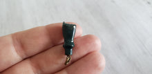 Load image into Gallery viewer,  Victorian or Edwardian antique green bloodstone carved fist charm with crystal magnifier inset in clenched hand, Gray Barn Eclectic Finds online vintage store, held in hand to show scale