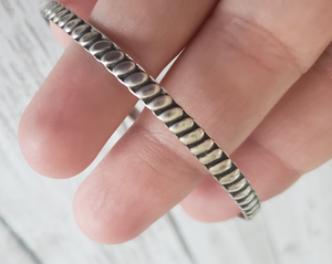 Vintage Sterling Silver 925 boho wide single bangle bracelet, Gray Barn Eclectic Finds online vintage store, held close to camera to show pattern