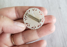 Load image into Gallery viewer, Estate Mother of Pearl MOP carved small sunflower brooch, Gray Barn Eclectic Finds online vintage store, reverse of brooch held in hand to show detail