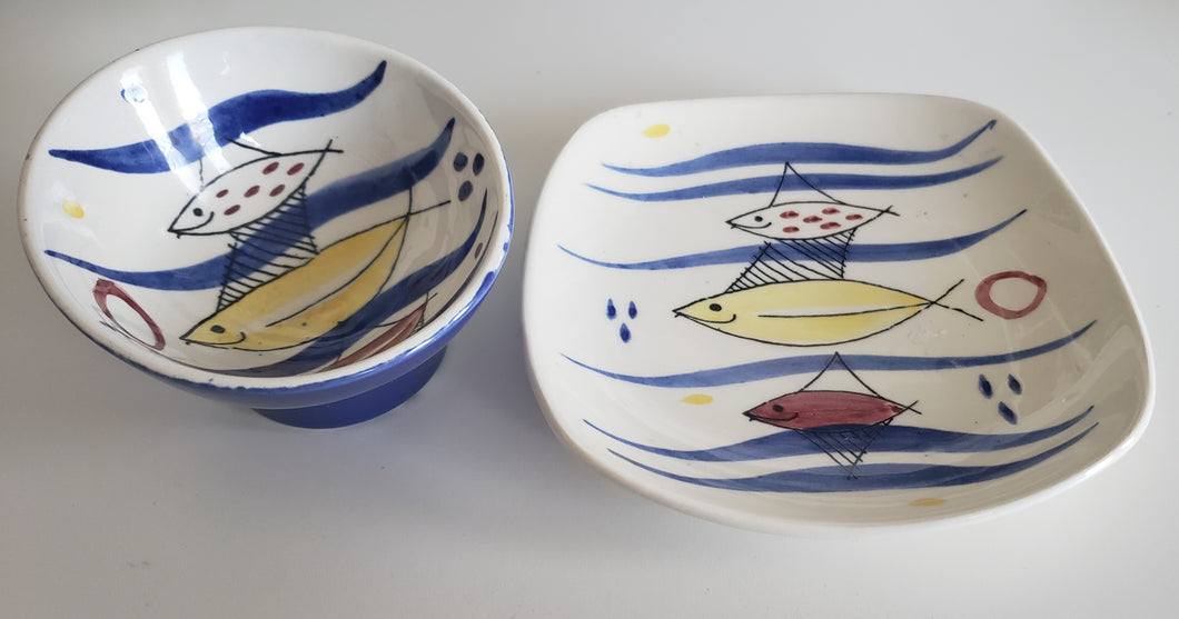 Stavangerflint Norway 1950s 1960s MCM atomic midcentury pottery with red yellow and blue fishes in cobalt blue waves, Gray Barn Eclectic Finds online vintage store, plate and bowl, side angle to show slope on bowl and curve on plate sides