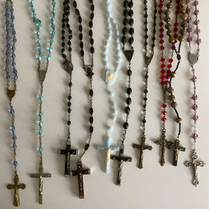 Vintage French rosaries, Gray Barn Eclectic Finds online vintage store, group of nine rosaries and chaplets photographed from overhead lying on a flat surface