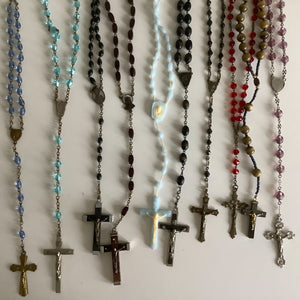 Vintage French rosaries, Gray Barn Eclectic Finds online vintage store, group of nine rosaries and chaplets photographed from overhead lying on a flat surface