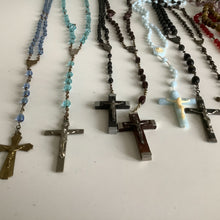 Load image into Gallery viewer, Vintage French rosaries, Gray Barn Eclectic Finds online vintage store, group of five roasries, blue crystal, aqua crystal, black bead, brown bead, blue plastic, and black bead shot length wise