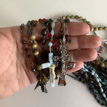 Load image into Gallery viewer, Vintage French rosaries, Gray Barn Eclectic Finds online vintage store, group of nine rosaries and chaplets held loosely in hand