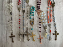 Load image into Gallery viewer, Group of vintage rosaries and chaplets on white wood background, Gray Barn Eclectic Finds online vintage store, overhead shot of them lying flat