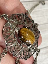 Load image into Gallery viewer, side profile of fliagree necklace to see colours of tiger eye cabochon