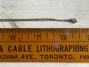 close up of the necklace closure on the vintage silver cross, showing a hoop and bar fastener, along with the length of about 17"